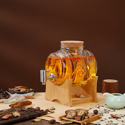 A 6 jin glass beverage dispenser with a cork stopper, clear ribbed glass body, and silver metal spout, shown on a wooden stand. The image includes Chinese text showing dimensions and decorative props like dried herbs and a small white teapot against a dark brown background.